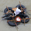 Residents make their way across a flooded street on a makeshift raft after Typhoon Morakot hit Cangnan county of Wenzhou, Zhejiang province, China on August 10, 2009. (REUTERS/Lang Lang)