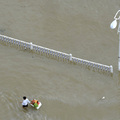 A resident pulls a box of groceries across a flooded street after Typhoon Morakot hit parts of Zhejiang province in China on August 10, 2009. (REUTERS/Lang Lang)