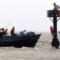 Rescuers try to reach a man who is stranded by floods as Typhoon Morakot approaches in Shanghai, China on August 9, 2009. (REUTERS/Stringer)