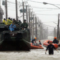 Evacuees sit on top of a military vehicle as rescuers search the flooded area for people after rains brought by Typhoon Morakot inundated the area in Chiatung, Pingtung county, in southern Taiwan, on August 9, 2009. (PATRICK LIN/AFP/Getty Images)