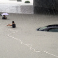 Rescuers try to pull a stranded car out of floodwater in Wenzhou, Zhejiang province, China on August 9, 2009. (REUTERS/China Daily)