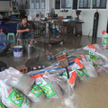 A worker sits behind a pile of sandbags as pumps empty floodwater from a workshop after Typhoon Morakot hit Fuzhou, Fujian province August 9, 2009. (REUTERS/Kong Nong)