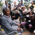 Nelson Mandela smiles for portraits by photo-journalists covering his homecoming shortly after he was released from prison. 13 February 1990. © Peter Turnley
 
