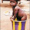 In Guinea, Amanda Loveday captured on film this baby, who was plonked in a bucket by his sister near Kindia.