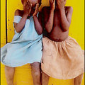 Also in Uganda, these sisters play peek-a-boo in Becca Mahood's photograph.