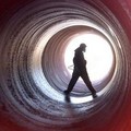 A Chinese worker sprays antiseptic in a pipe with a diameter of 2.6 m (8.5 feet) at a drinking water project in Ningbo in east China's Zhejiang province June 21, 2005. REUTERS/China Newsphoto