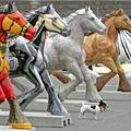 A dog walks past painted horses at the opening of the Horse Parade exhibition at the Jubilee Park in Brussels June 21, 2005. One hundred and seventy horses have been decorated for a three-month exhibition. REUTERS/Thierry Roge