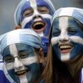 Greek soccer fans smile before their teams Confederations Cup soccer match against Brazil in Leipzig, Germany June 16, 2005. REUTERS/Michael Dalder