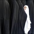 Before the vote : An Iranian girl stands among women queueing up outside a polling station in the Shiite holy shrine of Mahsoumeh for Iran's presidential elections. (AFP/Patrick Baz)