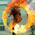 A Chinese soldier jumps through a burning ring during training at a military base in Jinan, east China's Shandong province, June 1, 2005. CHINA OUT REUTERS/China Newsphoto