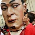 A reveller kisses 'cabezudo' (big head) during San Fermin's 'Comparsa de gigantes y cabezudos' (Parade of the giants and the big heads) in Pamplona July 8, 2005. REUTERS/Susana Vera