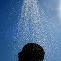 A boy takes a cool shower during a very hot day at Landa beach near the resort of Ayia Napa village on the southeastern coast of Cyprus, Tuesday, July 12, 2005. after temperatures had soared to 41 degrees . AP Photo/Petros Karadjias