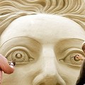 Sand art : Carvers Pavel Zadanyuk (R) from Russia and Sudarsan Pattnaik from India work on their sand sculpture allegorating a figure of the Greek mythology in Tossens, northern Germany. (AFP/DDP/David Hecker)