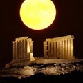 The full moon rises behind the ancient temple of Posseidon, in Sounio about 73 kilometers (45 miles) south-east of Athens, on Thursday, July 21, 2005. (AP Photo/Petros Giannakouris)