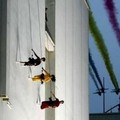 Artists perform on a wall during a show in the presence of Belgian royal family in downtown Brussels July 21, 2005. REUTERS/Thierry Roge