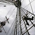 A Russian crew member tends to the rigging on one of the ships as the crew prepares for the Tall Ships race out of Newcastle July 25, 2005. The ships will race from Newcastle to Fredrikstad in Norway on Thursday 28, July. REUTERS/Ian Hodgson