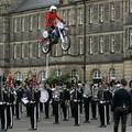 A member of the Imps Motorcycle display team jumps over the Guard of His Majesty The King of Norway Band and Drill team, Edinburgh,Aug. 3, 2005.  ( AP Photo/PA, Andrew Milligan)