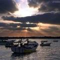 The sun sets behind Palestinian fishing boats in Gaza City's seaport, Tuesday, Aug. 2, 2005. Israel is set to evacuate all 21 Gaza Strip settlements and four more in the West Bank in mid-August. (AP Photo/Khalil Hamra)