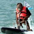 An orang-utan plays on water skis at an event marking 100 days to the Asia-Pacific Economic Cooperation meeting in Pusan, southeast of Seoul, August 10, 2005. REUTERS/Yonhap