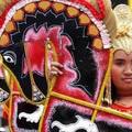 An Indonesian woman from Central Java carries trance dance horses known as 'Kuda Lumping' during a cultural carnival, celebrating the country's 60th anniversary of independence, in Jakarta, August 21, 2005. REUTERS/Supri