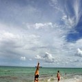 People are seen on the coast in Fort Lauderdale, while Tropical Storm Katrina forms over central Bahamas and heads towards Florida's southern Atlantic Coast August 24, 2005.  REUTERS/Carlos Barria