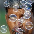 Indian street seller Shabuddin, (45) blows soap bubbles as he sells bottles of bubble solution for Indian rupees 10 (US $ 0.22) at India Gate in New Delhi. (AFP/Manan Vatsyayana)