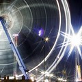 The big wheel turns in the night at Munich's Oktoberfest beer festival with its lightened merry-go-rounds and roller coasters. (AFP/DDP/Timm Schamberger)