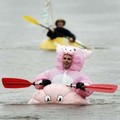  in front of the 600lb (272 kg) pumpkin boat being paddled by Martha Stewart Living Associate Location Producer Maryanne Vanderventer in the Windsor-West Hants Pumpkin Regatta in Windsor, Canada, October 9, 2005.  REUTERS/Paul Darrow