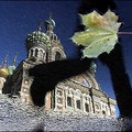 A passer-by jumps over a puddle reflecting the Cathedral of Our Savior in St. Peterburg. INTERPRESS / SERGEI KULIKOV (AFP/INTERPRESS/Sergei Kulikov)