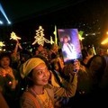  hold signs and posters of 'Pretty' of the contestants as they watch the singers perform during a concert in the people's stadium in Beijing Sunday Oct. 9, 2005.  (AP Photo/Elizabeth Dalziel)