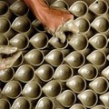 A potter makes earthen lamps in Agartala, India, Tuesday Oct. 18, 2005. Diwali, the Hindu festival of lights, will be celebrated across the country on Nov. 1. (AP Photo/Ramakanta Dey)