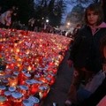 A girl stands near candles at the Mirogoj cemetery in Zagreb, Croatia, Tuesday, Nov. 1, 2005.