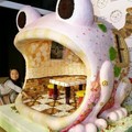 一名日本女孩11月3日在東京好奇地坐在這隻可愛的青蛙糖果屋旁。根據主辦單位表示，他們用了超過120種各式巧克力、餅乾、糖果才完成這個可愛的創意。 路透/Yuriko Nakao (發稿:李婷儀/劉瑞芬)