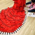 A chocolatier decorates a dress with chocolate