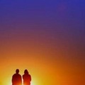 Two teenagers observe the sunrise