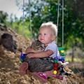 Baby and Cat in a Swing